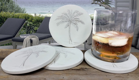 palm tree coasters sitting by the beach